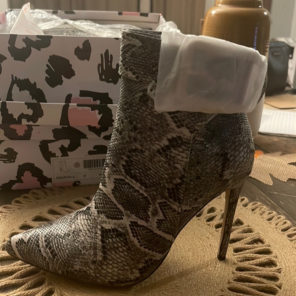 Zebra style ankle high heel boots size 9. Never worn brand new